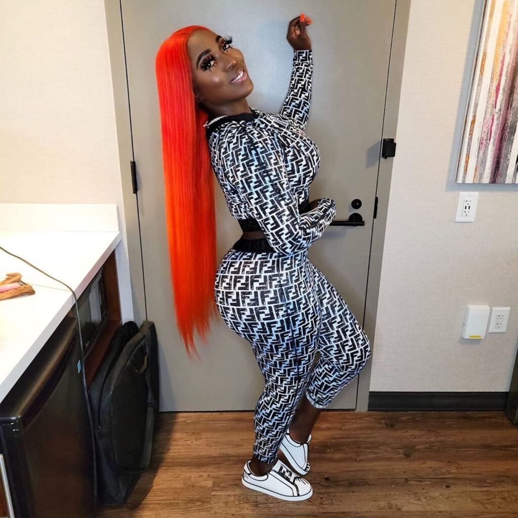 Dancehall artist Spice Rocks Red Hair With Matching Black And White Fendi Jersey Top And Leggings