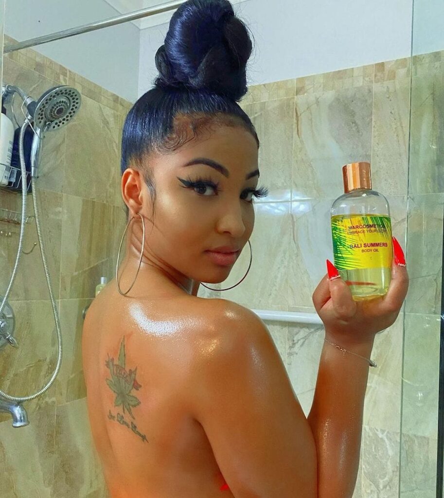 Shenseea Shows Off Her Back Tattoo showing 'Weed Leaves' with Quotes 'YOLO' and Live Love Laugh