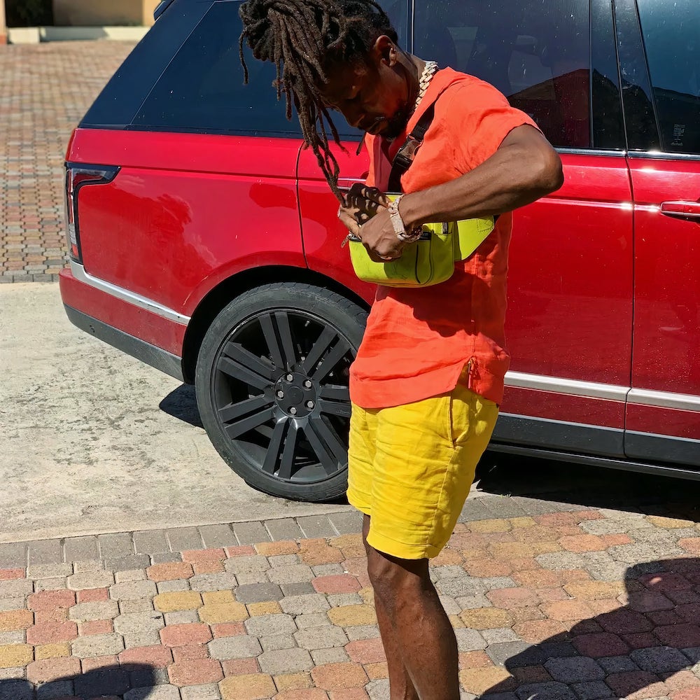 Jah Cure Sports Red Outfit In His Red Range Rover 3